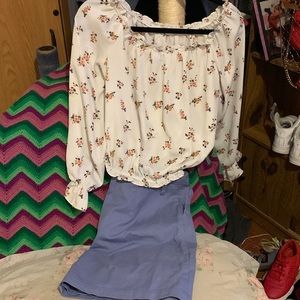 A cute outfit of a floral shirt with ruffles and a cute mid skirt